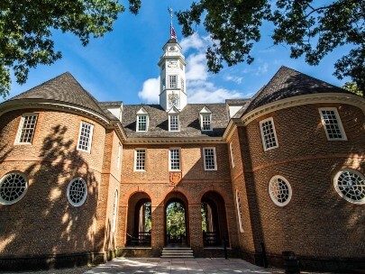 Large brick building with two circular ends and arched pathway in the middle