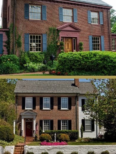 Two stately brick homes with shuttered windows, trees and lush landscaping with bushes